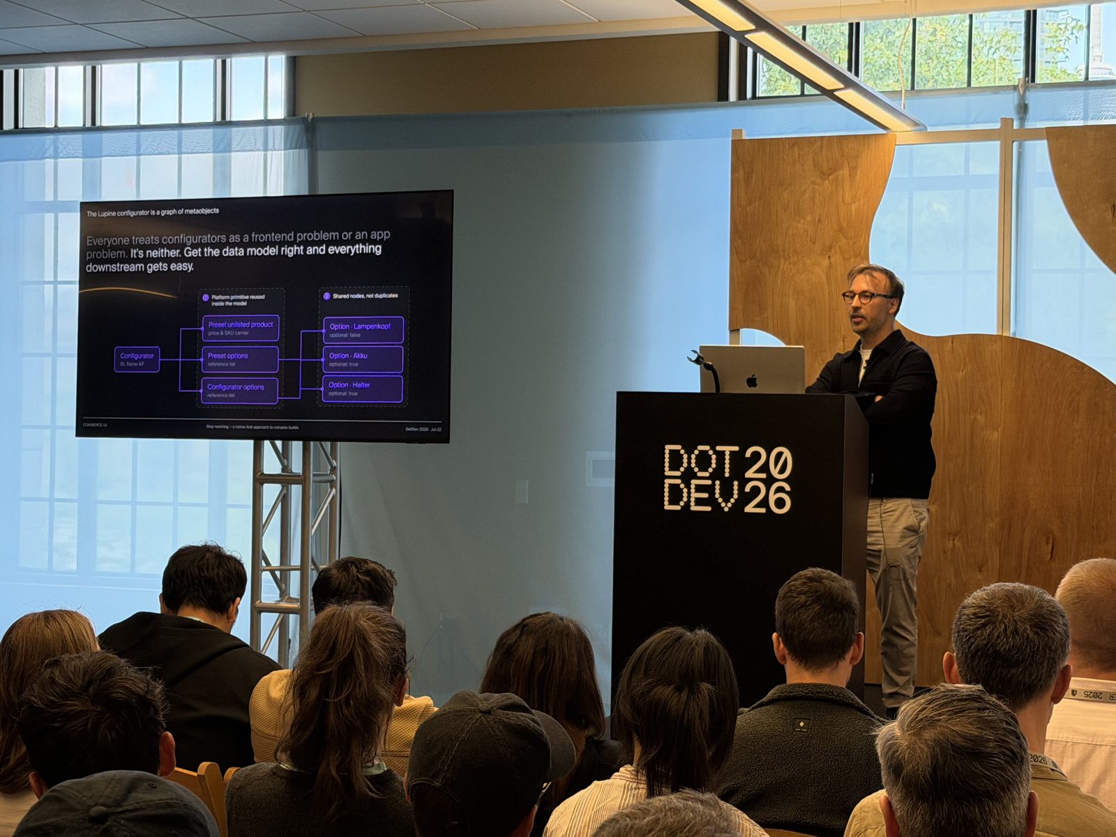 A speaker on stage at DotDev 2026
